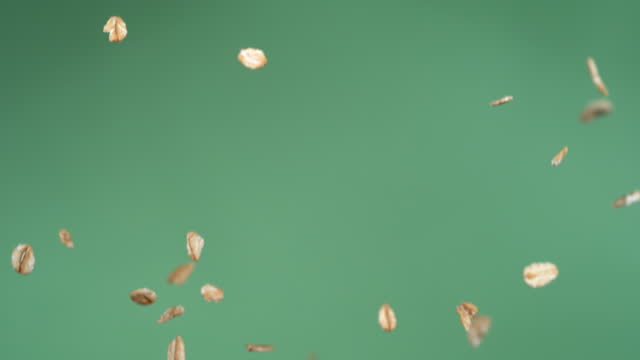 Oats flying up in slow motion, green screen.  Shot with Phantom Flex 4K camera.