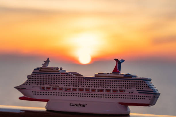 Editorial image of the cruise ship Costa Deliziosa docked at the port of Argostoli on the island of Kefalonia, Greece. Tourists disembark and walk along the pier under a clear blue sky, showcasing the vibrant atmosphere of summer tourism in the Ionian Islands.