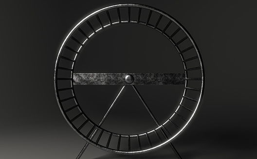 A close up of an empty metal hamster wheel on an isolated dark studio background - 3D render
