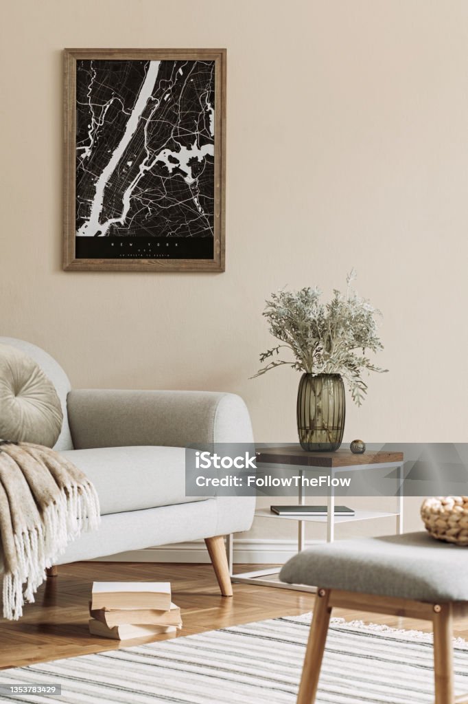 Modern composition of living room interior with brown mock up poster frame, design retro commode, sofa, bookstand, rattan basket with plant and elegant accessories. Template. Stylish home staging. Home Interior Stock Photo