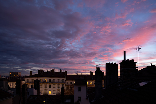 Morning light where the rooftops of the city of Lyon stand out in a pink atmosphere