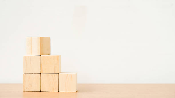 istock blank flipped square wooden cube on top of stack for create icon symbol to success, goal or target concept 1353783764