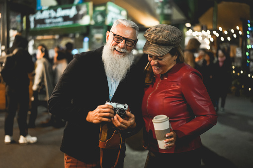 Senior couple having fun in london city at evening time - Soft focus on senior man face