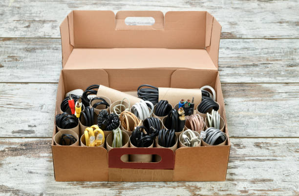 Lifehack; Organize cords using empty toilet paper tubes in a shoebox Organizing power and USB cables using empty toilet paper tubes in shoebox lifehack stock pictures, royalty-free photos & images