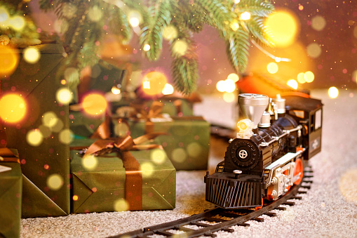 Toy train under Christmas tree. Home party decoration