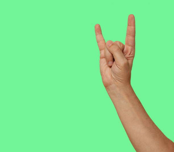 istock Hand shows sign goat on isolated green screen background 1353789590