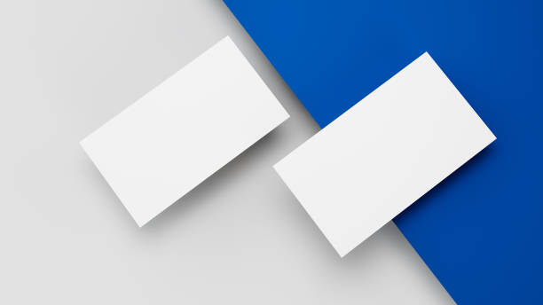 istock Two white US business card Mockup laying on blue and grey background. card front and back laying on colored surface 3D Illustration 1353789700