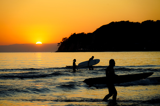 Twilight of Kamakura coast and surfer silhouette. Shooting Location: Kamakura, Kanagawa Prefecture