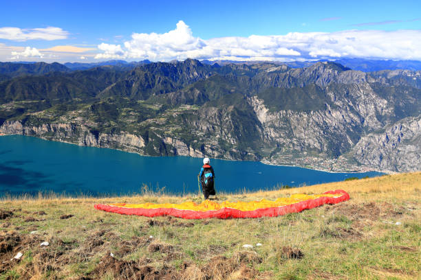 Paraglider on Mount Baldo looking west to Lake Garda. Northern Italy, Europe. stock photo