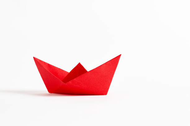 istock Origami red paper boat on white background 1353792754