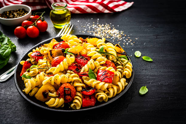 istock Vegan pasta salad plate on black background 1353794177