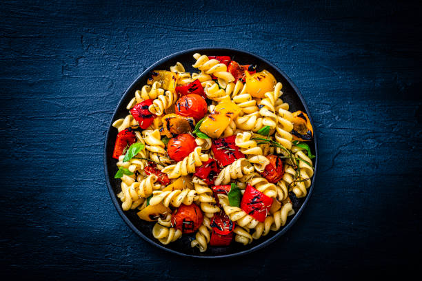 istock Top view of a pasta salad plate on dark background 1353794178