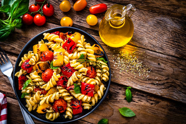 istock Healthy pasta salad plate on rustic table. 1353794198