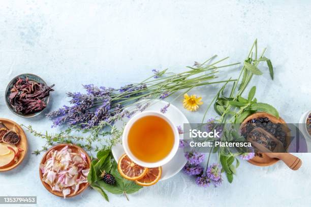 A Cup Of Tea With Dry Fruit Flowers And Herbs Shot From The Top Stock Photo - Download Image Now