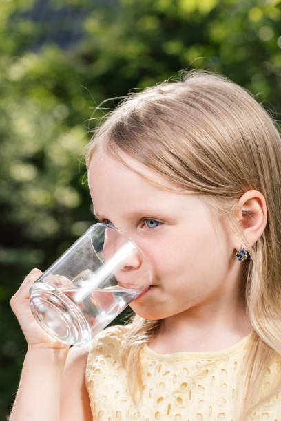 istock Child drinking water outdoors 1353795470