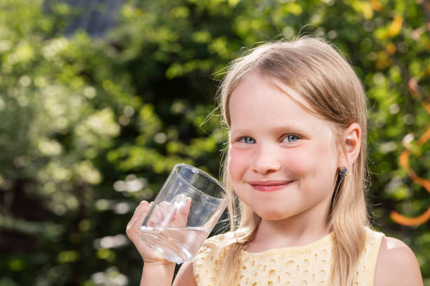 istock Child drinking water outdoors 1353795891