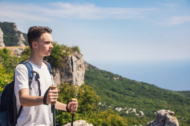 Teen boy explorer on a cliff