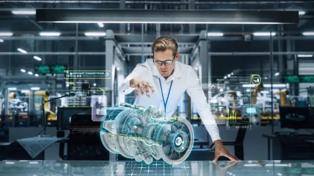 Confident Engineer in White Shirt Working on Jet Engine with Use of Augmented Reality Hologram in an Office at Plane Assembly Plant. Industrial Specialist Working in Technological Development Facility