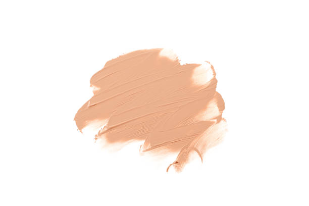 istock Light beige makeup smear of creamy foundation isolated on white background. Liquid foundation smudge. 1353797321