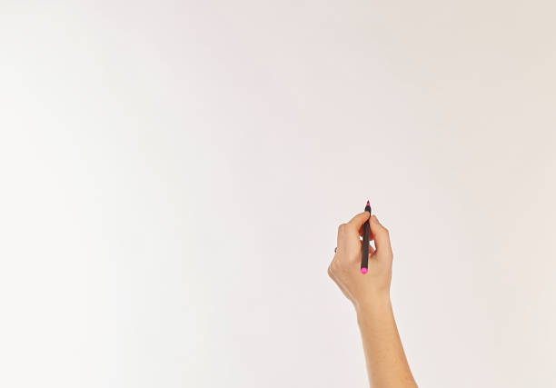 istock A female hand is ready to draw with a black marker. 1353799944