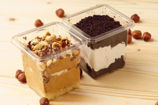 istock Creamy dessert in a plastic box on wooden table 1353800348