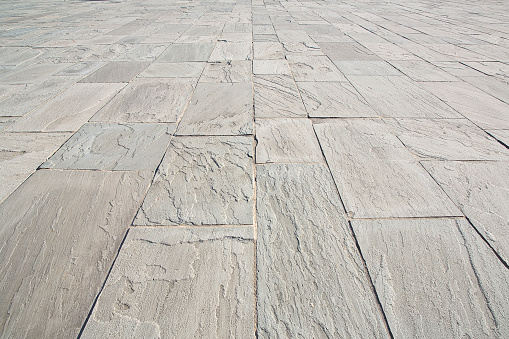 New paving made with gray split stone blocks of rectangular shape in a pedestrian zone