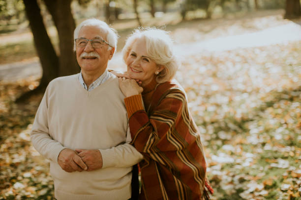 istock Senior couple embracing in autumn park 1353800948