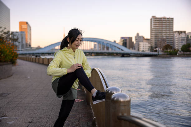 istock Female athlete stretching at riverside 1353800972