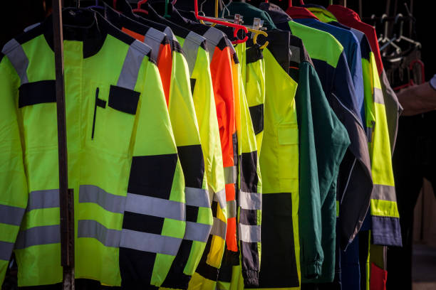 istock Selective blur on high visibility safety coats and jackets, personal protective equipments, for sale outside, fluorescent colors. These coats are made to be visible on workplace in any condition. 1353802914