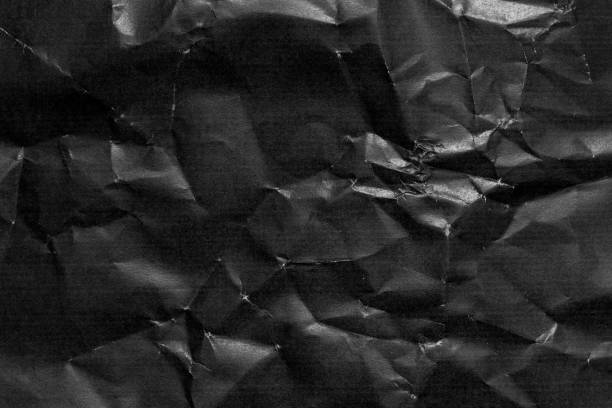 istock Grunge wrinkled black color paper textured background 1353803793
