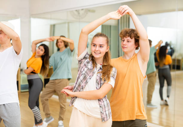 istock Youth boys and girls dancing salsa indoors 1353804315