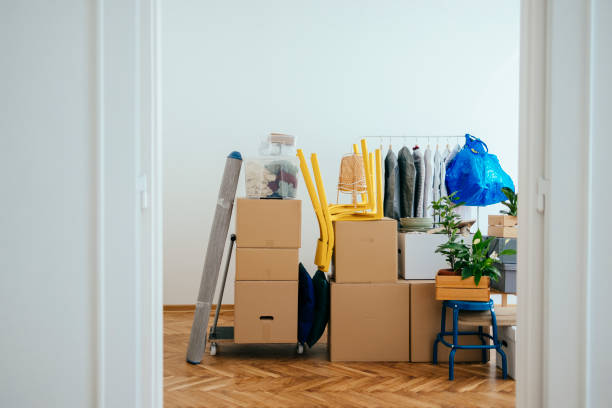 Interior with Packed Cardboard Boxes and Other Stuff Ready for Relocation Packed boxes on top of each other in a corner of the room ready for relocation. belongings stock pictures, royalty-free photos & images