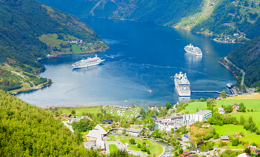 Cruise ship at Geirangerfjord near Geiranger village aerial view in Norway