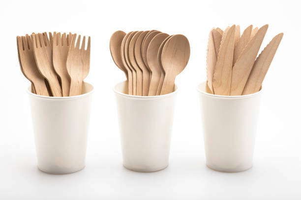 istock Wooden spoon and fork with knives in paper cup  , disposable tableware on a white background. Eco-friendly materials 1353806818