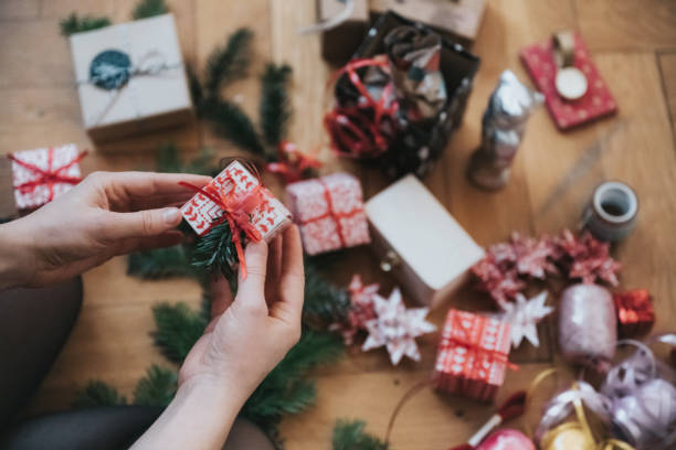 istock female hands holding little christmas gift box 1353807965