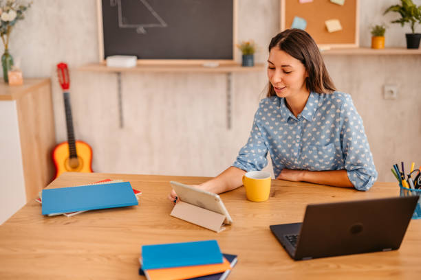 istock Woman math teacher lecturing online from home on her tablet 1353808175