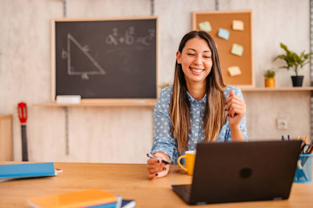 istock Woman math teacher lecturing online from home on her laptop 1353808445