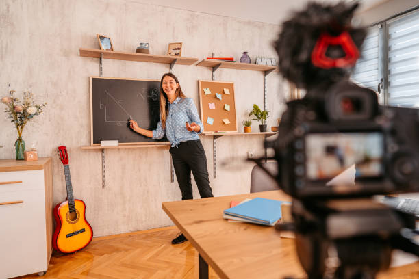 istock Woman math teacher lecturing online from home in front of camera 1353808493