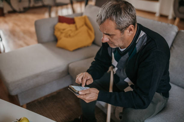 istock The elderly man uses a smartphone 1353809746