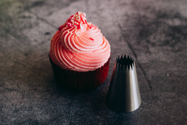 istock Delicious cupcakes. Cupcakes and confectionery attachments for cream 1353811282