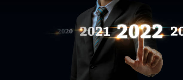 istock Goal target. businessman hand touching and pointing on year 2022 with virtual screen on dark background, change from 2021 to 2022, strategy, investment, business planning and happy new year concept 1353811391