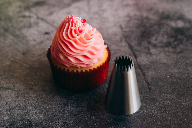 istock Delicious cupcakes. Cupcakes and confectionery attachments for cream 1353811778