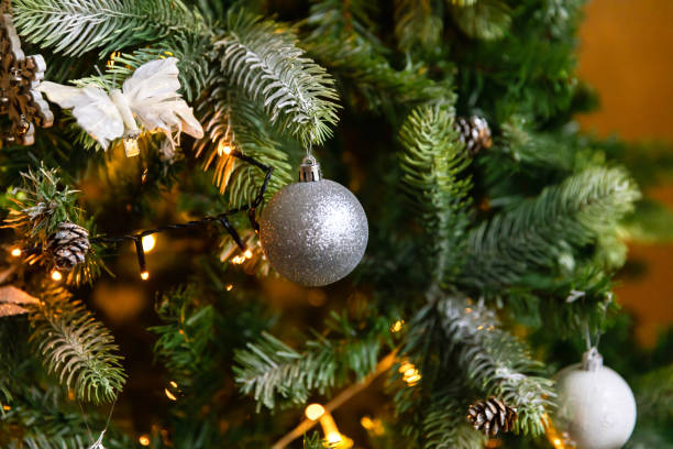 istock Classic Christmas decorated New year tree. Christmas tree with wite and silver decorations, ornaments toy and ball. Modern classical style interior design apartment. Christmas eve at home 1353812311