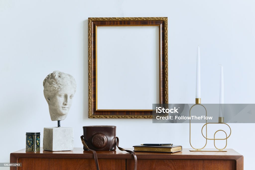 Unique artist workspace interior with stylish furniture, wooden easel, bookcase, artworks, painting accessories, decoration and elegant personal stuff. Modern work room for artist. Template. Picture Frame Stock Photo