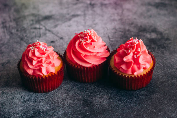 istock Delicious cupcakes. Cupcakes on a concrete table 1353814216