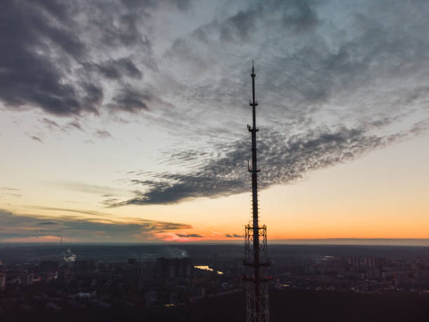 istock Aerial sunset epic city view with telecom tower 1353814217