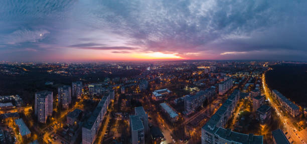 istock Aerial evening view, illuminated city streets pano 1353814340