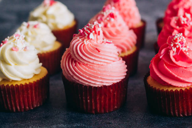 istock Delicious cupcakes. Cupcakes on a concrete table 1353814480