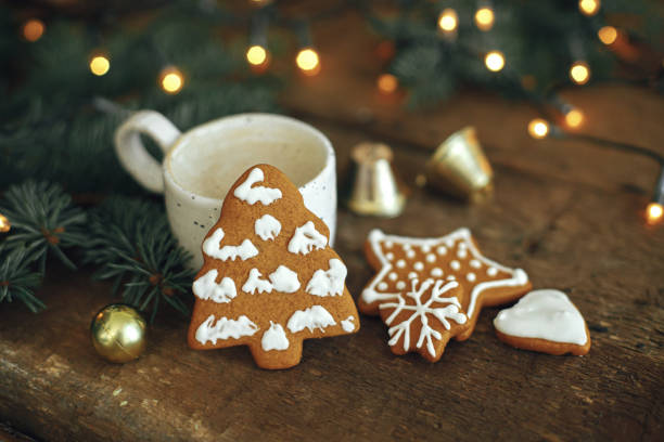 istock Christmas tree gingerbread cookie, coffee, fir branches on rustic table.Winter time. Merry Christmas 1353815985
