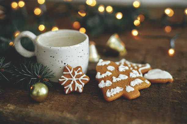 istock Merry Christmas! Gingerbread cookies, coffee, fir branches on rustic table with warm lights 1353816130